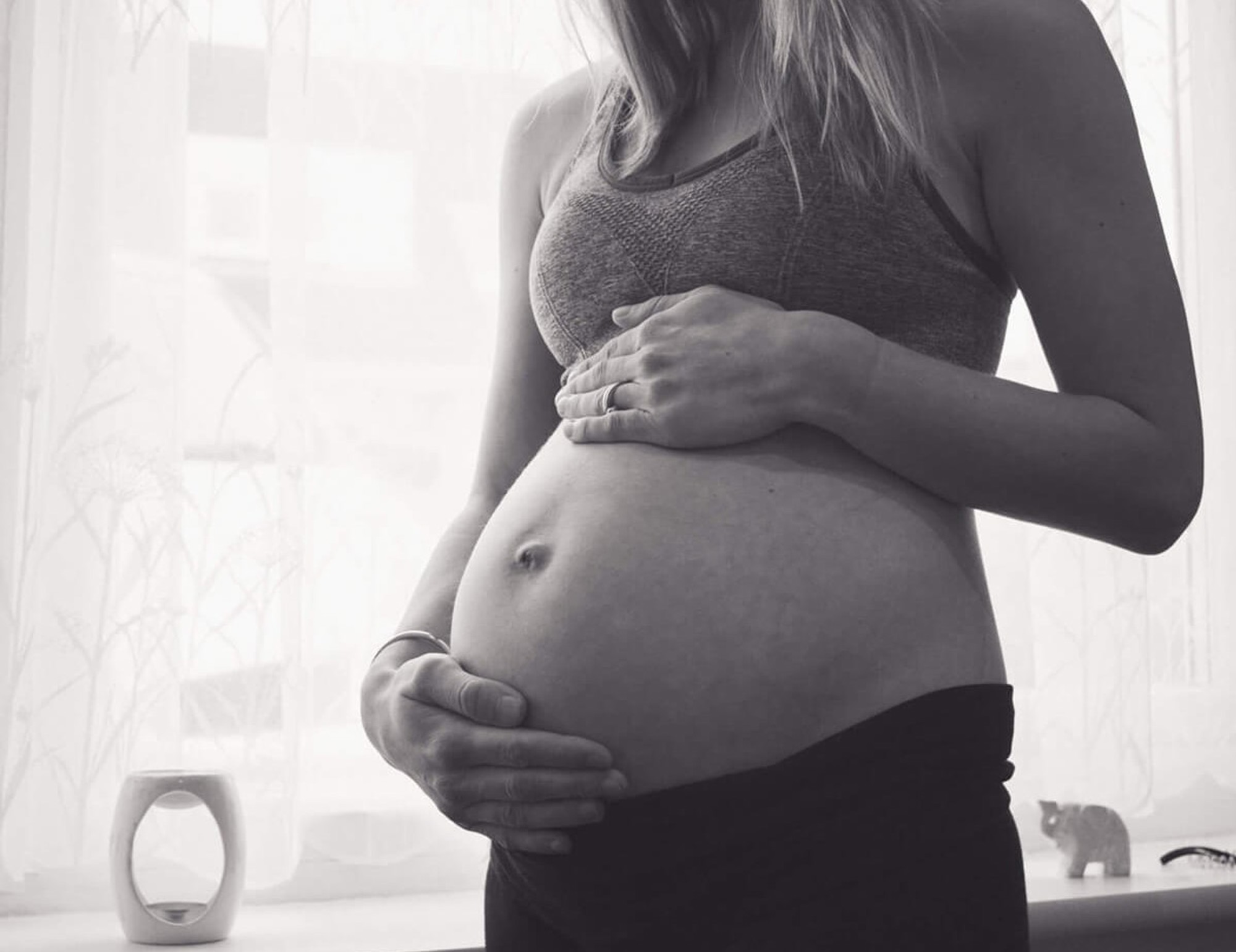 Sinead pregnant in her studio and holding her bump